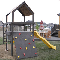 Play structure including a climbing wall
