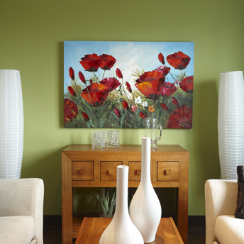 Artwork pops against a celery green wall