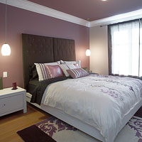Bedroom with a purple accent wa