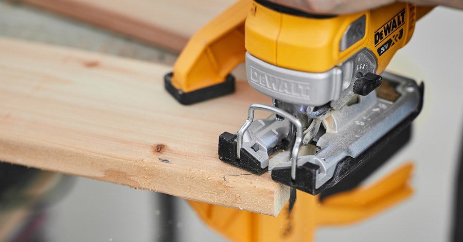Person cutting a corner using a jigsaw