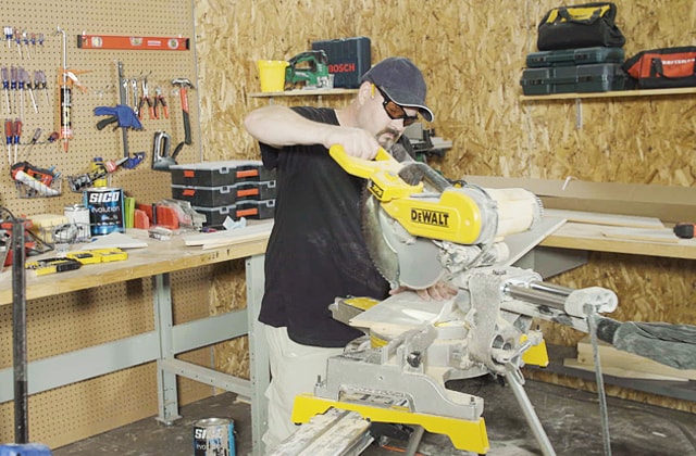 Person using a mitre saw to cut wood