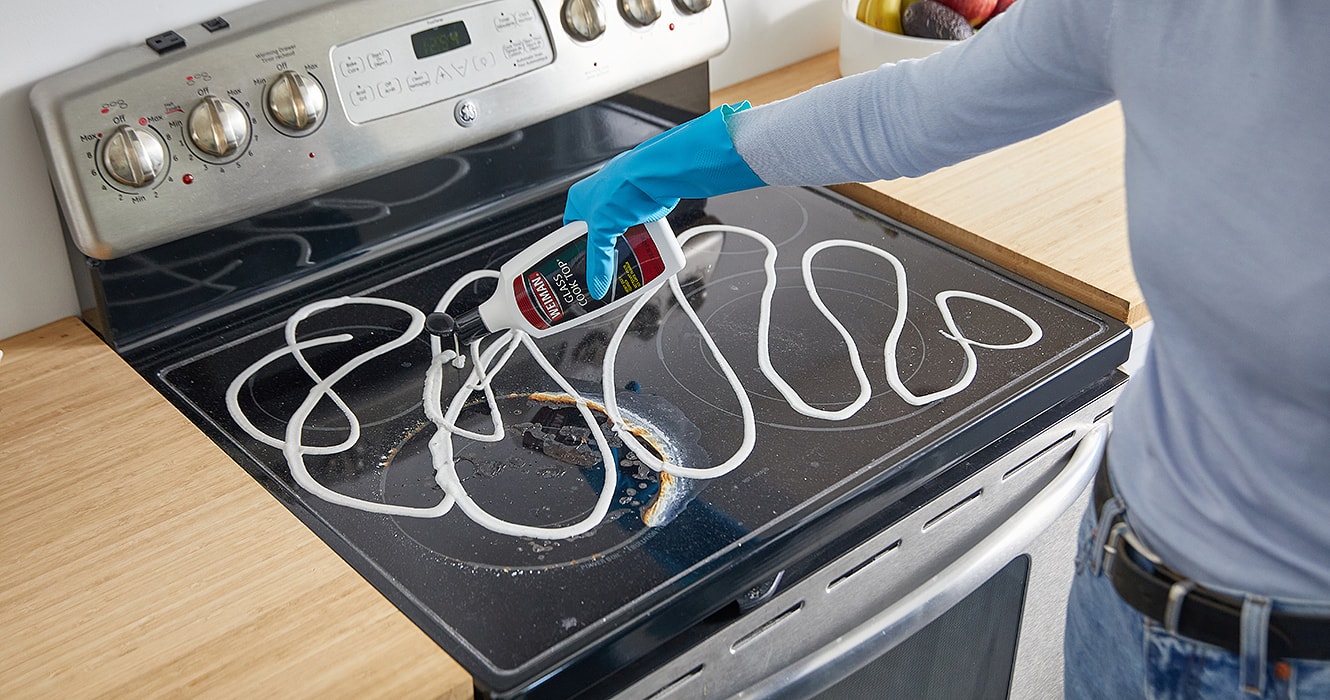 Person pouring cooktop cleaner