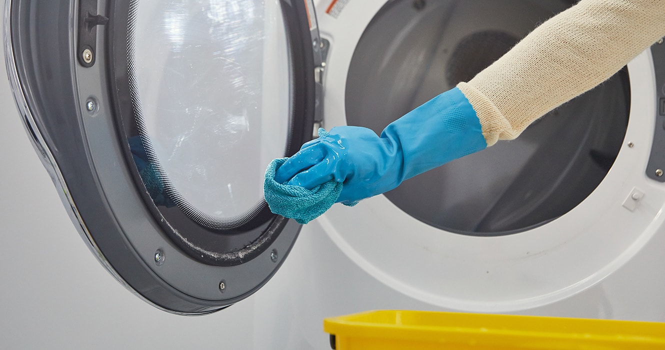 Person cleaning a dryer door