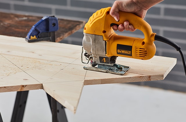 Person cutting wood with a jigsaw