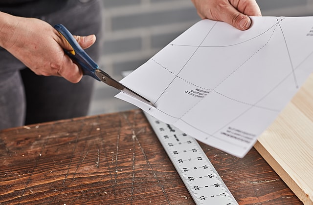 Person cutting a sheet of paper