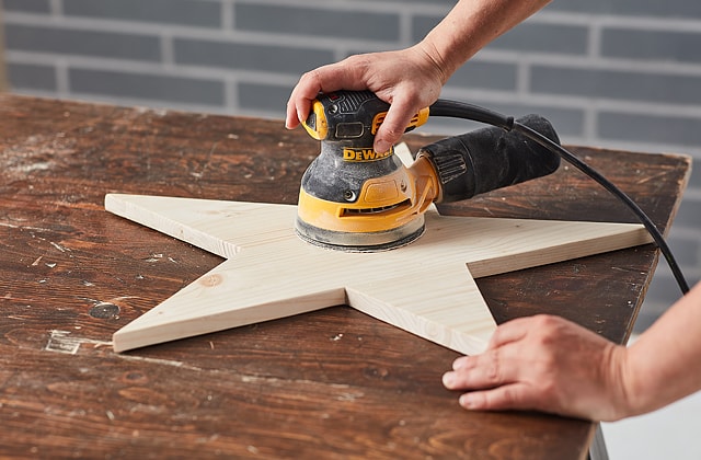 Person using a power sander