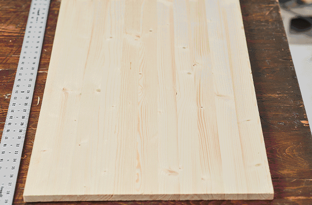 Animated image of a person tracing a star on a wooden board