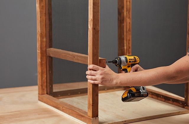 Person adding a drawer support to a wooden structure
