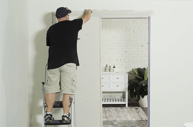 Person finishing joints on a wall