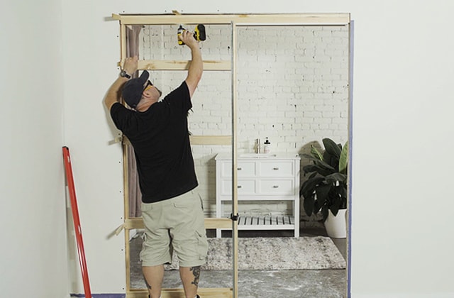 Person installing a pocket door frame