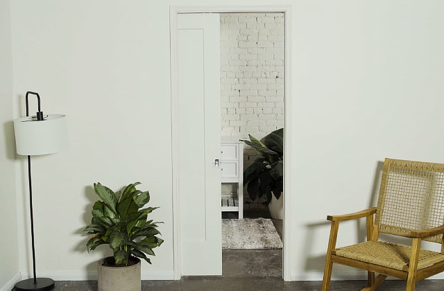 Light grey room with a pocket door