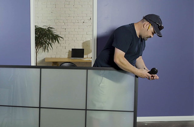 Person installing hangers on a sliding barn door