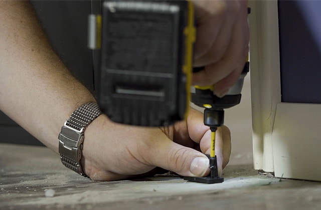 Person installing sliding door stoppers