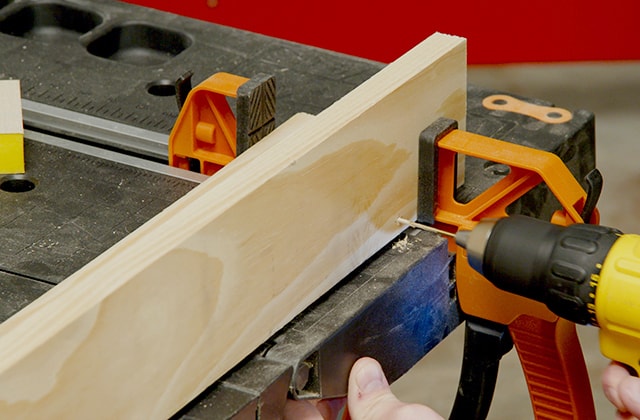 Man assembling a wall shelf