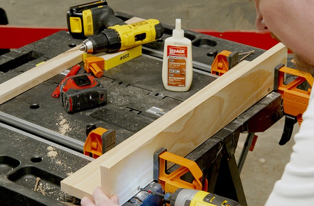 Man assembling a wall shelf