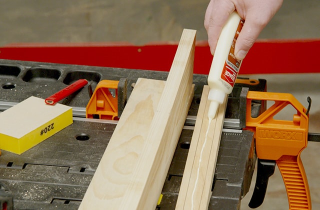Man assembling a wall shelf