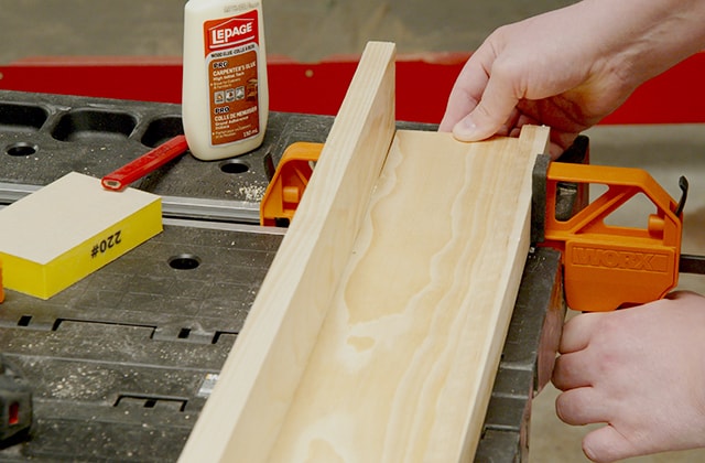Man assembling a wall shelf