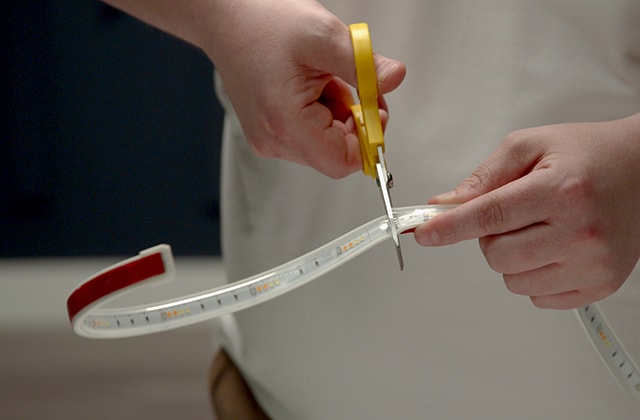 Man cutting an LED strip