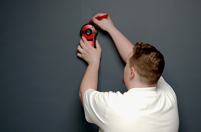 Man using a stud finder