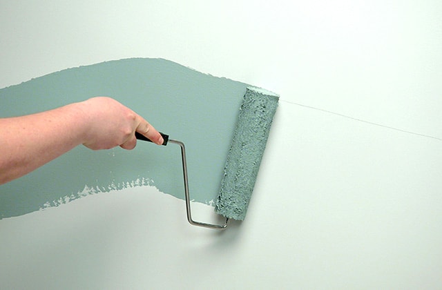 Person applying paint with a roller