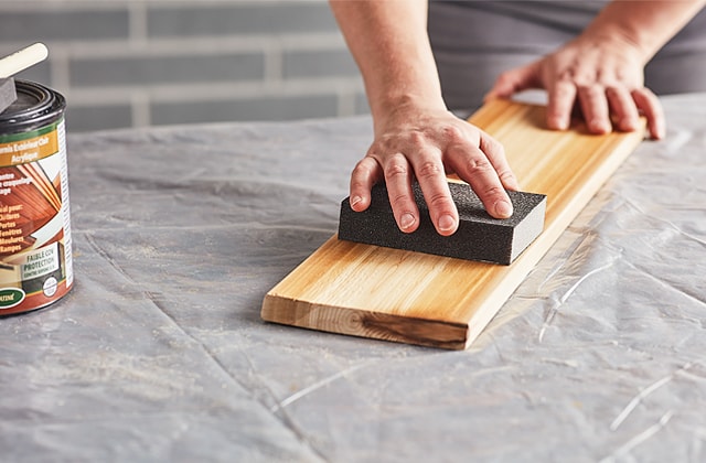 Person sanding a piece of wood