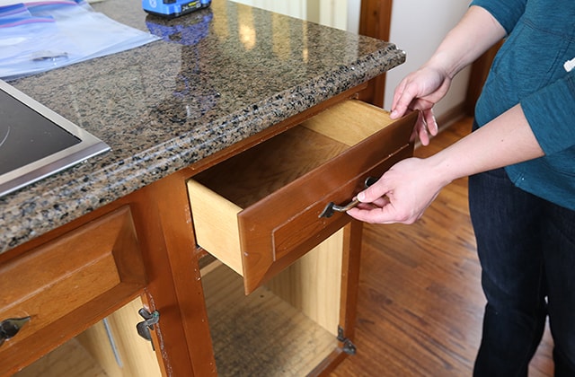 Person removing kitchen drawers