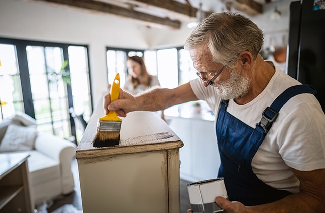 Man painting furniture