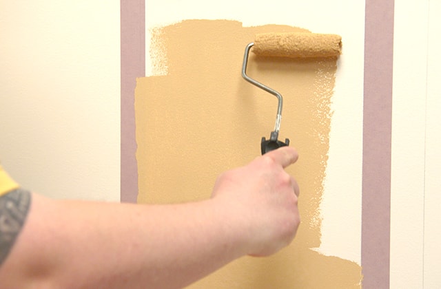 Man painting an arch on a wall
