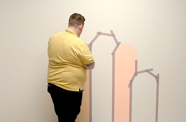 Man applying tape on a wall