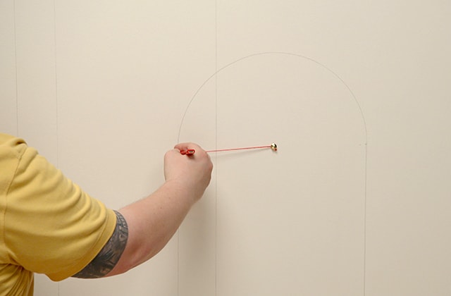 Man tracing a semicircle