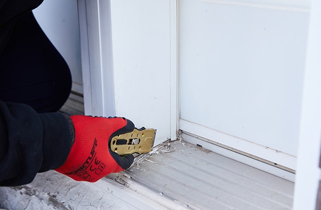 Person scraping caulk residue