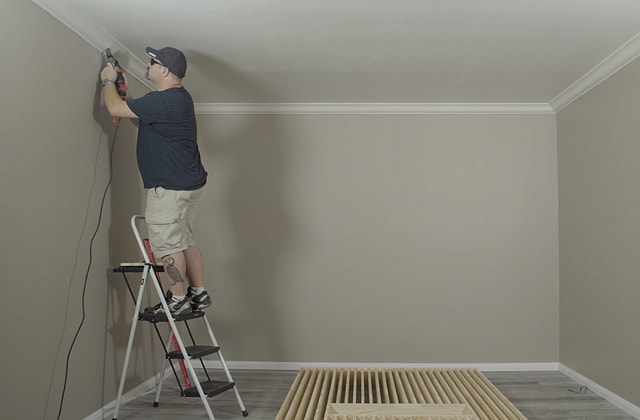 Person removing moudling using an oscillating tool