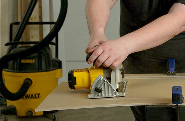Person cutting a tile