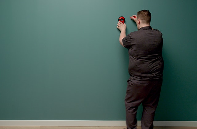 Person using a stud finder