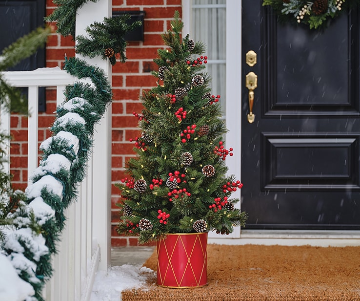 Potted artificial tree on a front porch