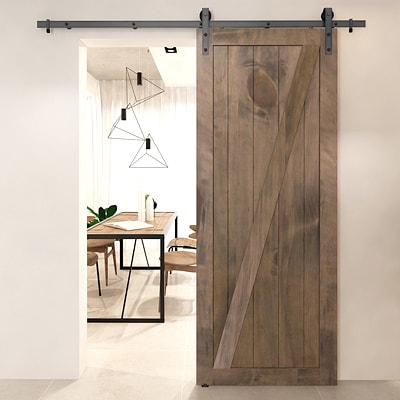 Rustic barn door leading to a dining room