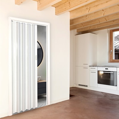 Kitchen with a folding door leading to a bathroom