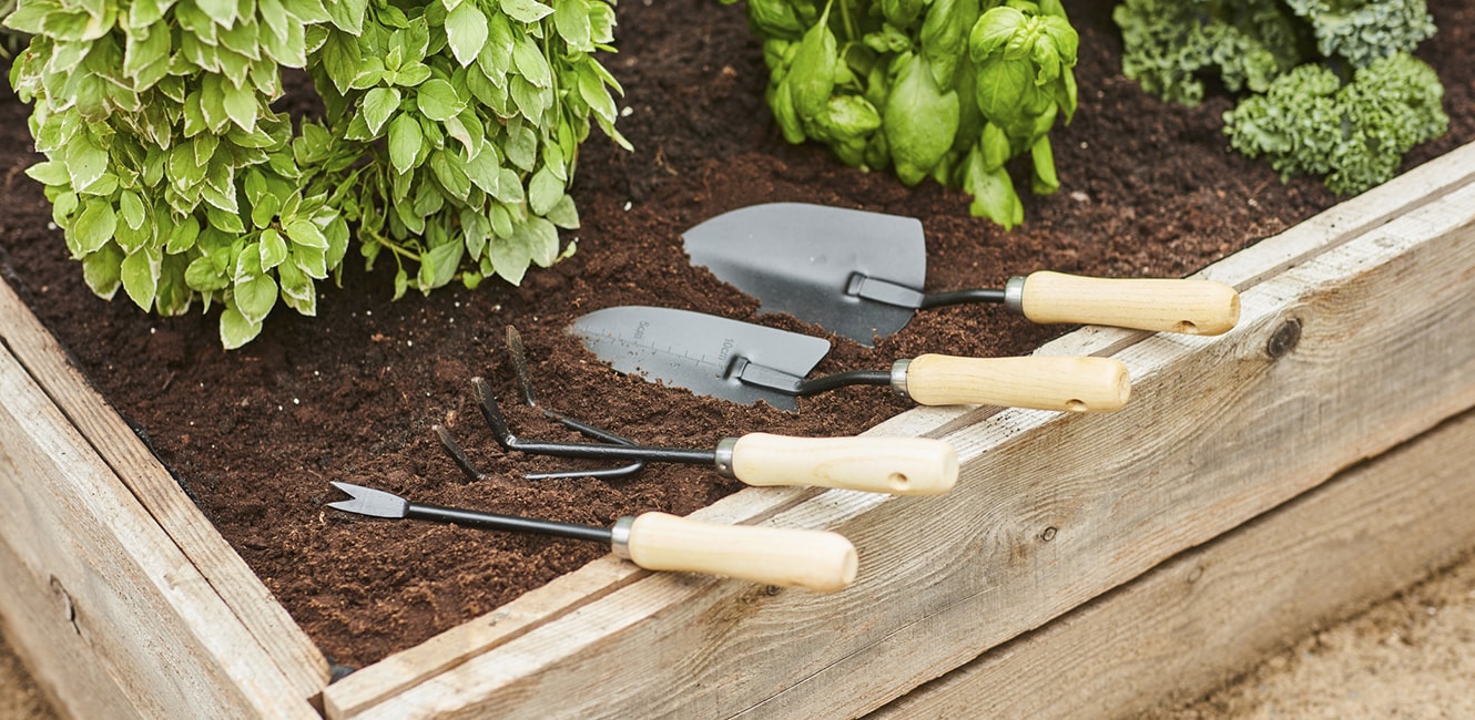 Gardening tools on a raised bed