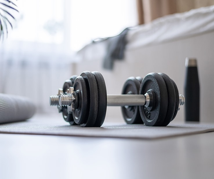 Weightlifting equipment on a bedroom floor