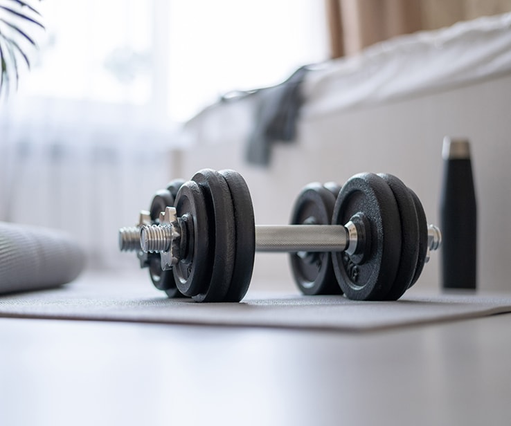 Weightlifting equipment on a bedroom floor Weightlifting equipment on a bedroom floor