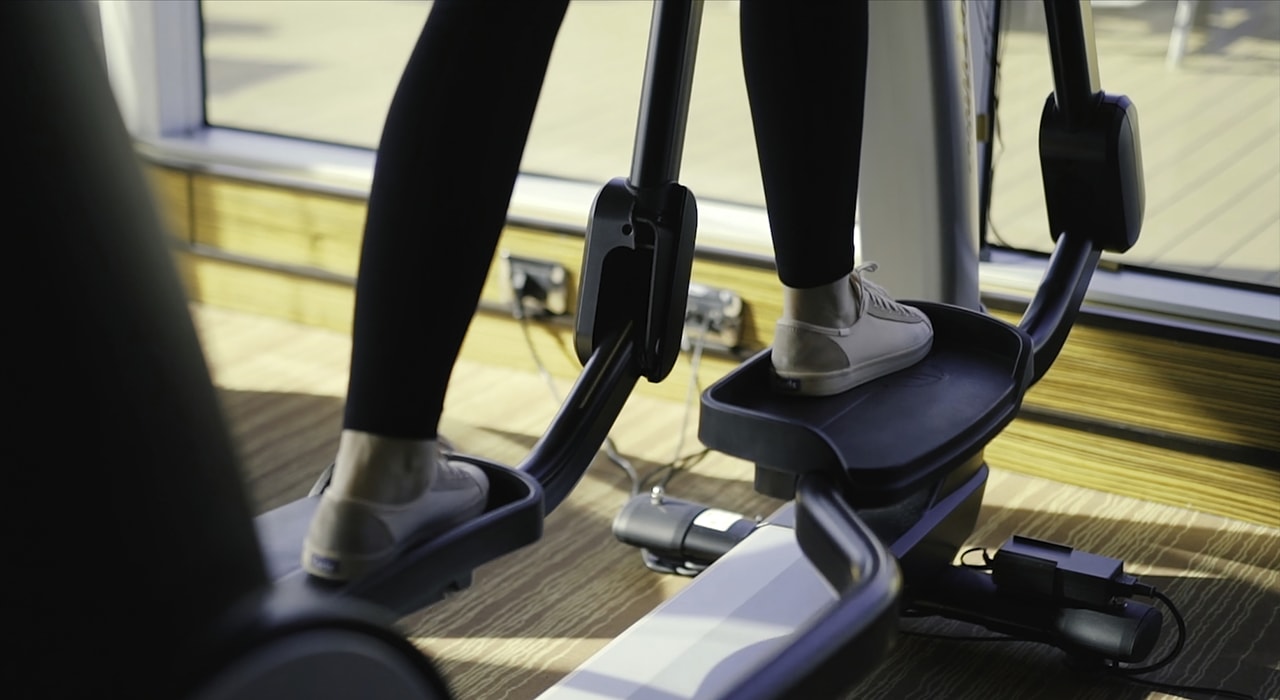 Woman using an elliptical fitness machine