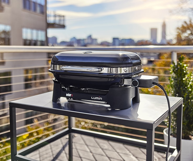 A portable electric BBQ on a small patio