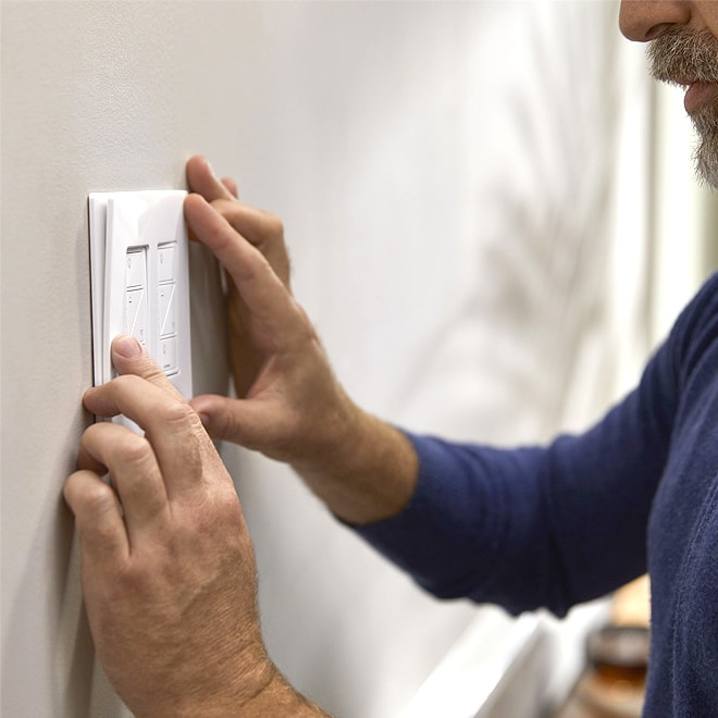 Man installing a smart light switch