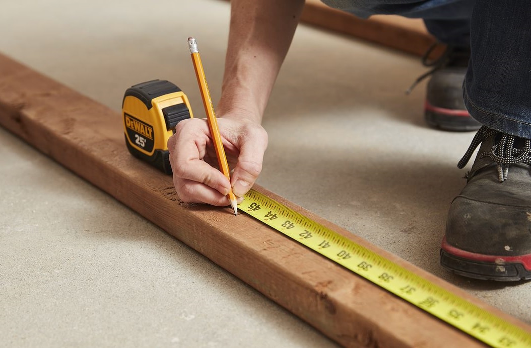 Person using a measuring tape Person using a measuring tape