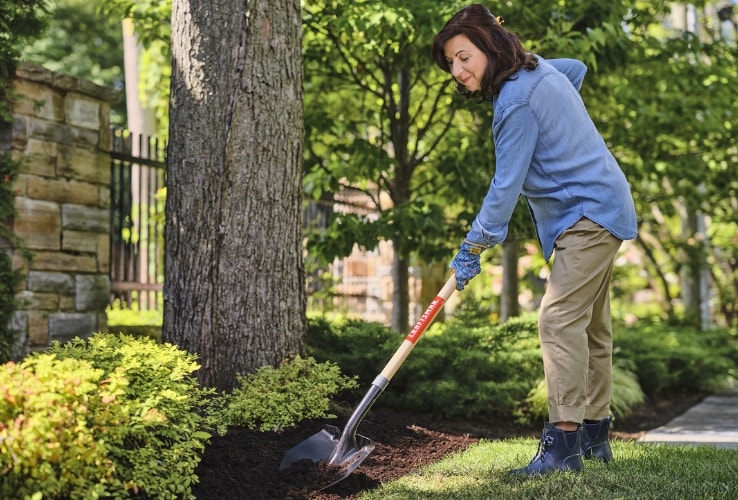 Woman maintaining a garden bed Woman maintaining a garden bed