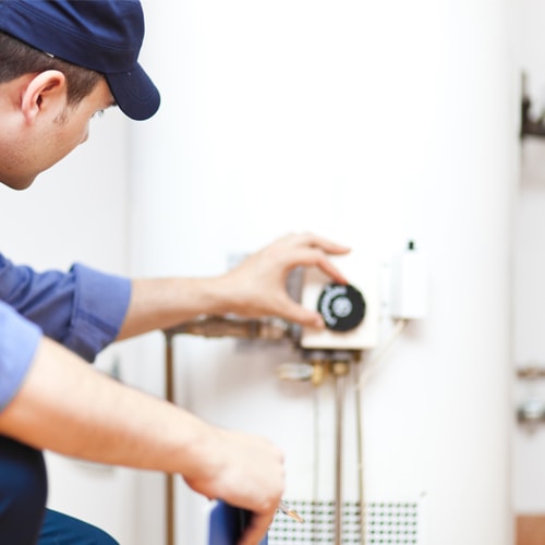 Person maintaining a hot water heater