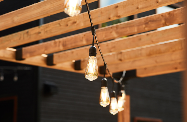 String lights hanging from a wooden pergola