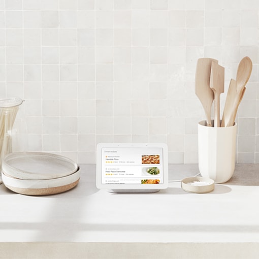 Google Nest Hub in Chalk on a kitchen counter Google Nest Hub in Chalk on a kitchen counter
