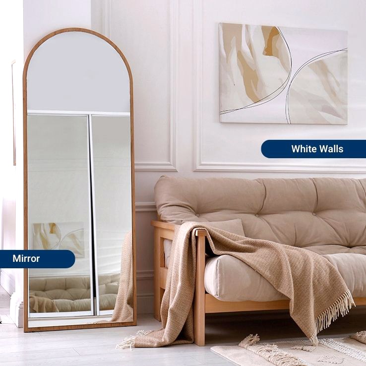 Living room with white walls and a large mirror