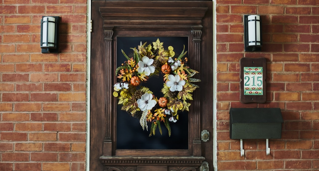 Wooden front door with a fall wreath Wooden front door with a fall wreath